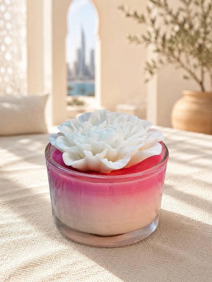 Pink ombre flower candle with the Dubai skyline behind