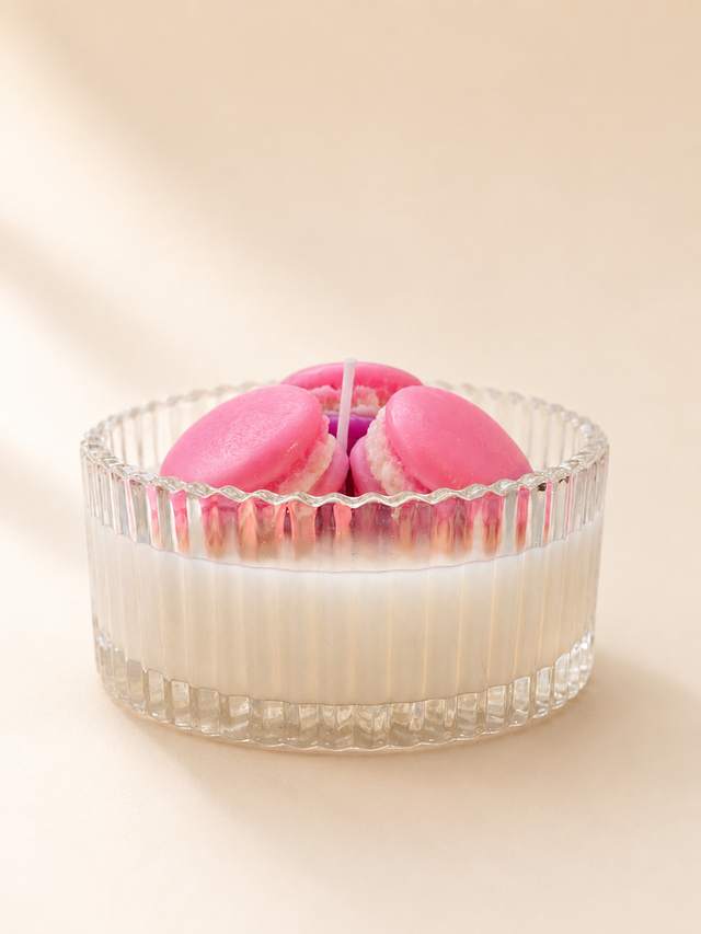 Candle topped with pink wax macarons
